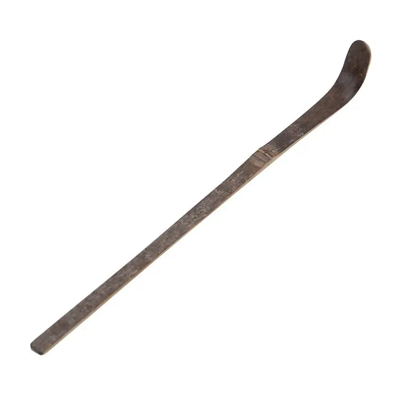 Dark brown bamboo matcha scoop on a dark background