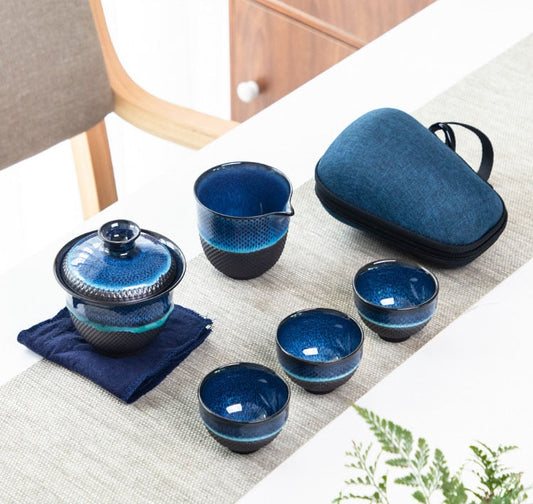 Blue enameled teapot and gaiwan with loose-leaf tea ready to brew