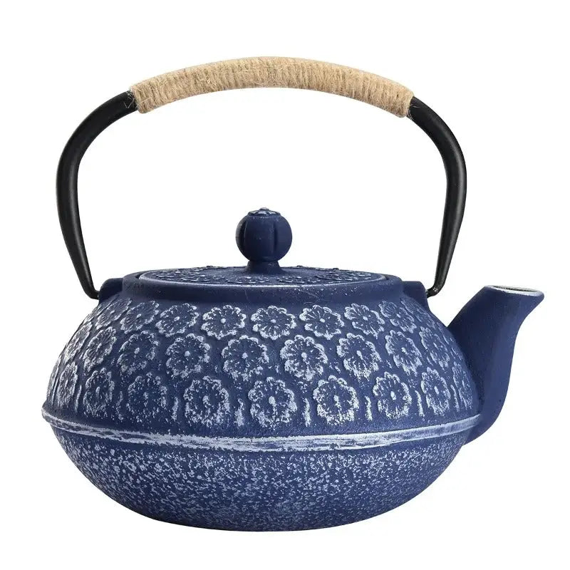Blue enamel cast iron teapot side view showing flower motif detail