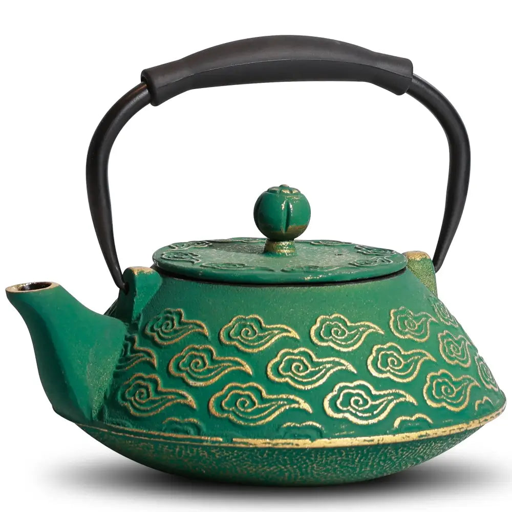 Green cast iron teapot with infuser and tea leaves