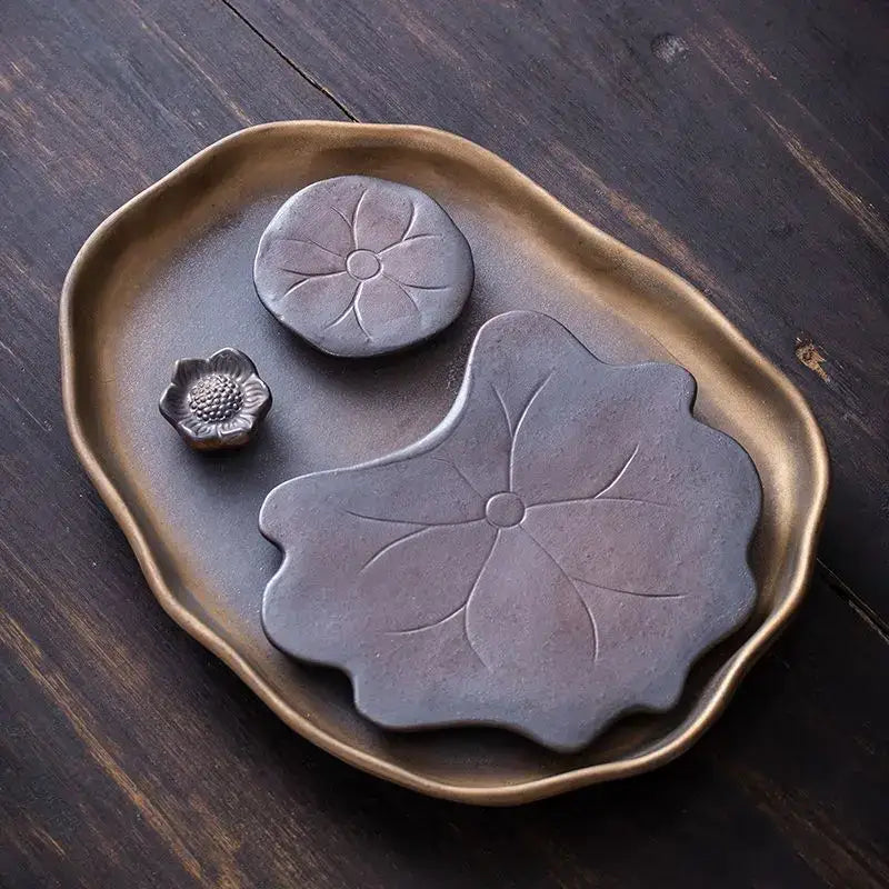 Brown ceramic leaf tea tray on a table