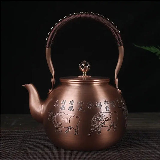 Chinese copper teapot 1.5 L - hand-carved bull motif detail in warm copper finish