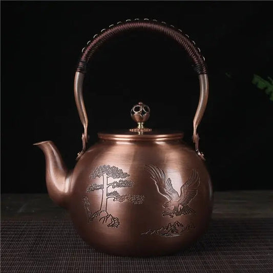 Chinese copper teapot eagle motif 1.5L showing engraved detail and patina