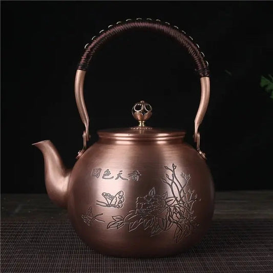 Close-up of hand-etched floral and butterfly motif on Chinese copper teapot 1.5L