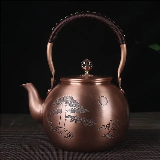 Hand-engraved full moon design on Chinese copper teapot, close-up detail