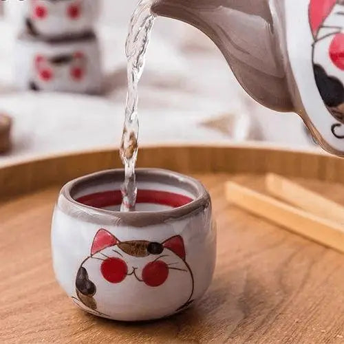Pouring tea from cat teapot