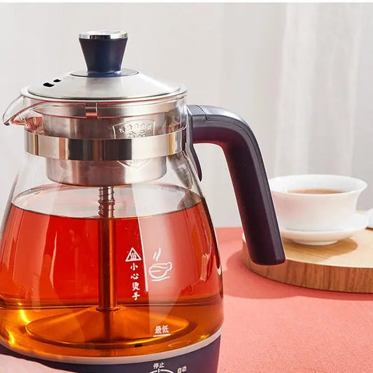 Electric tea infuser pouring hot tea into a cup