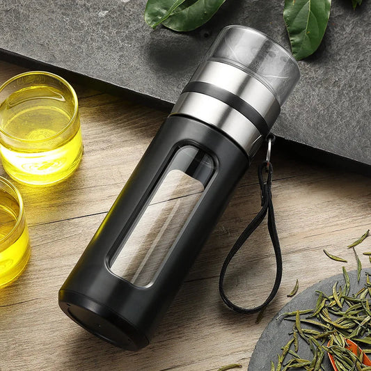 Clear borosilicate glass tea infuser bottle showing removable stainless steel filter detail