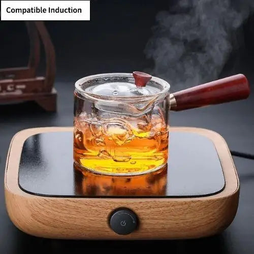 Induction compatible glass teapot sitting on black induction cooktop