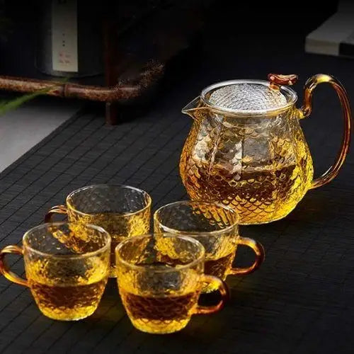 Multiple glass teapots with strainers displayed together