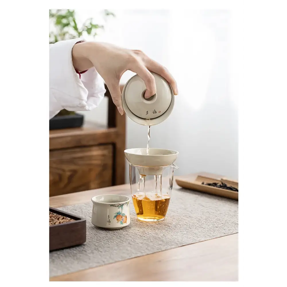Porcelain tea strainer with tea cup and saucer