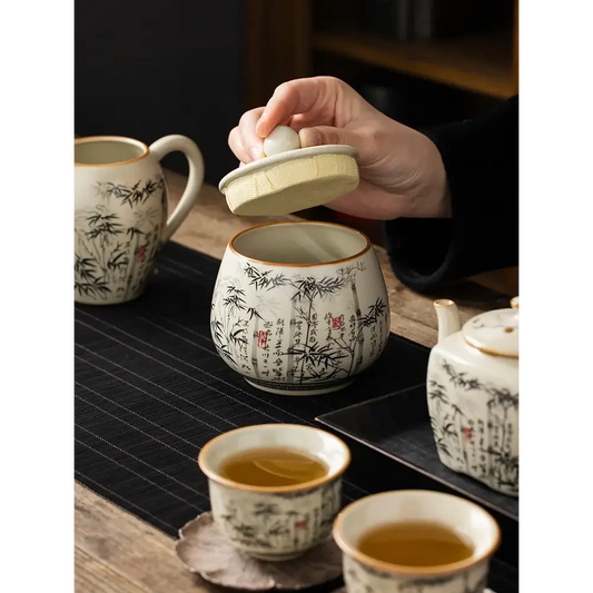 Ceramic tea storage jar with hand-painted bamboo motif and natural bamboo lid