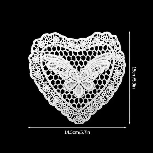 Butterfly heart absorbent cotton fabric coaster under a white teacup on wooden table