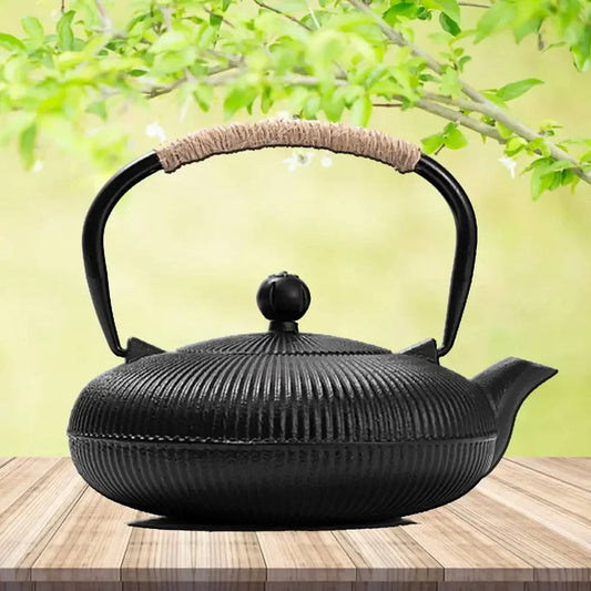 Japanese cast iron teapot with lid on wooden table