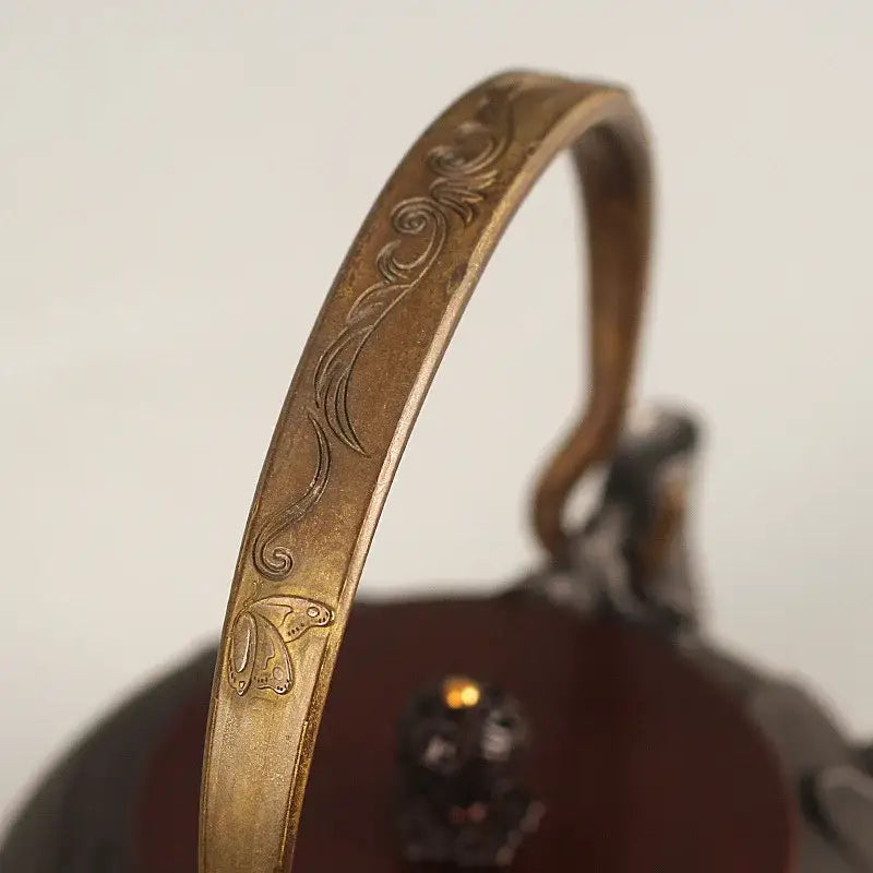 Japanese cast iron teapot 1.2L dragon motif on kitchen counter with tea cups