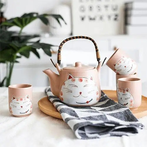 Porcelain cat teapot on wooden table