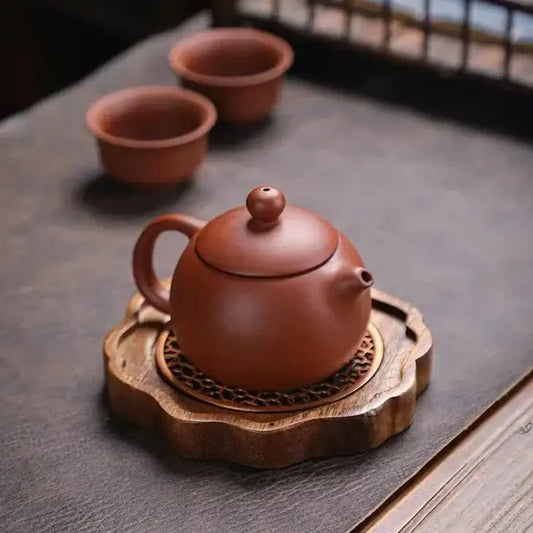 Close-up of decorative grid cut into natural wood teapot trivet surface