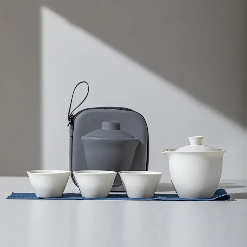 White porcelain teapot set with two cups