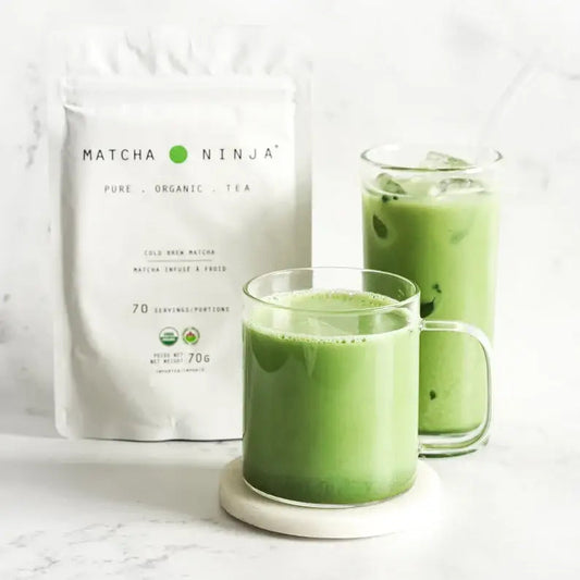 Matcha green tea powder in a tin with a spoon