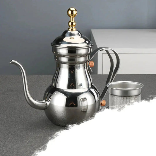 Pouring hot tea from Oriental stainless steel teapot with long curved spout