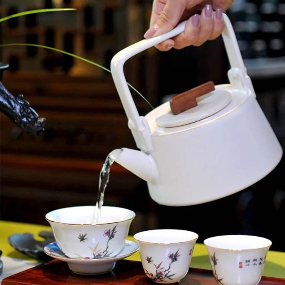 Hygge teapot with tea leaves nearby