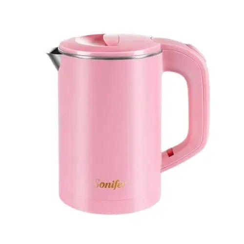 Small electric tea kettle in rose pink on kitchen counter