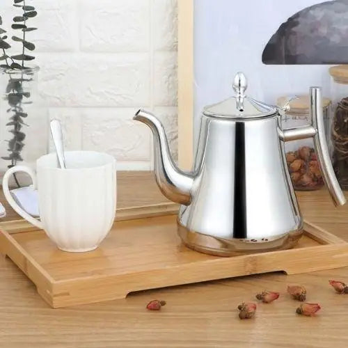 Stainless steel teapot with infuser basket removed and displayed