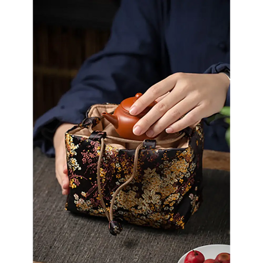 Portable teapot carrier bag showing padded interior compartments