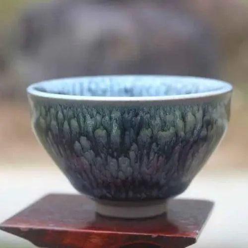 Close-up of tenmoku iron glaze swirling pattern on handmade Japanese stoneware bowl