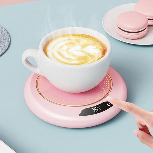 USB mug warmer plugged into a laptop USB port on a desk