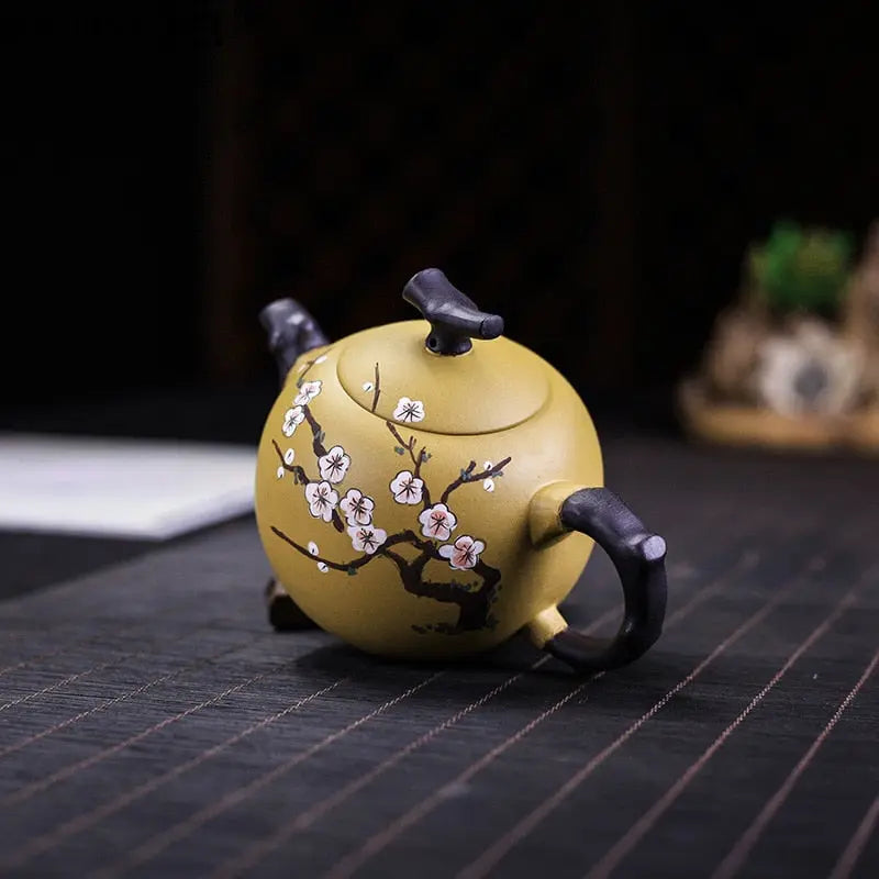 Yixing clay teapot 250ml on wooden tea tray with cherry blossom pattern visible