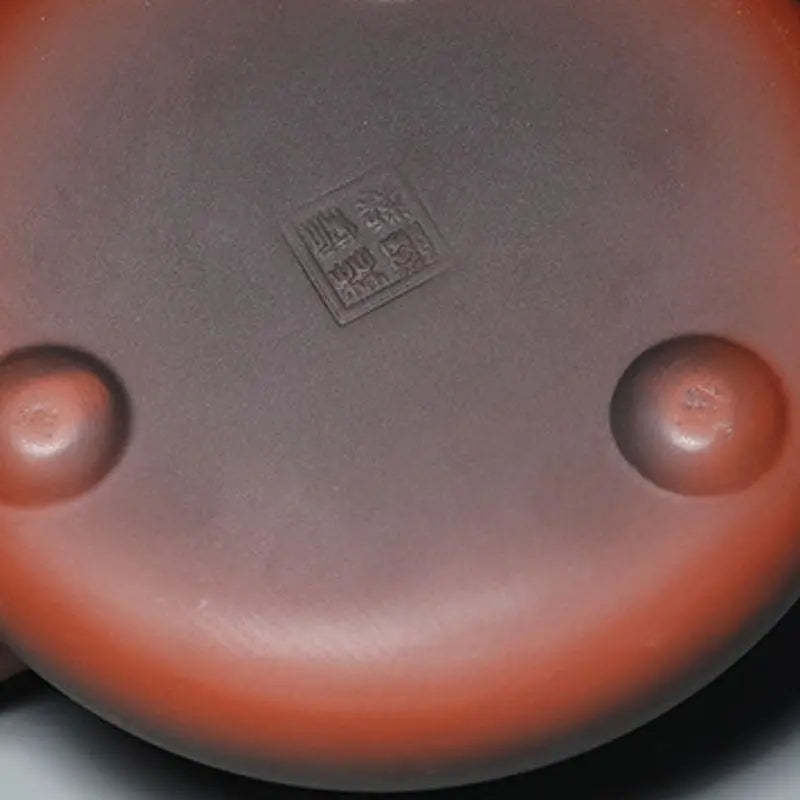 Yixing teapot with traditional symbols on wooden tray, gongfu tea setting