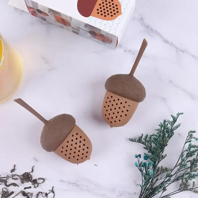 Acorn tea infuser steeping in a glass mug