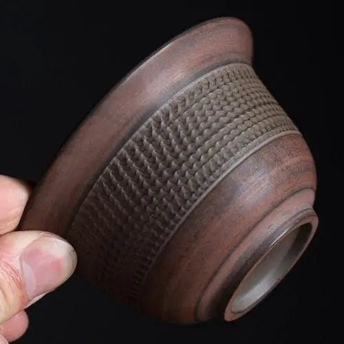Side profile view of brown stoneware gaiwan tea bowl