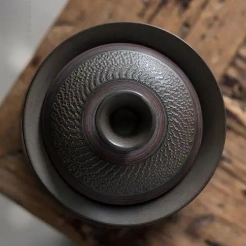 Top-down view of open gaiwan tea bowl stoneware interior