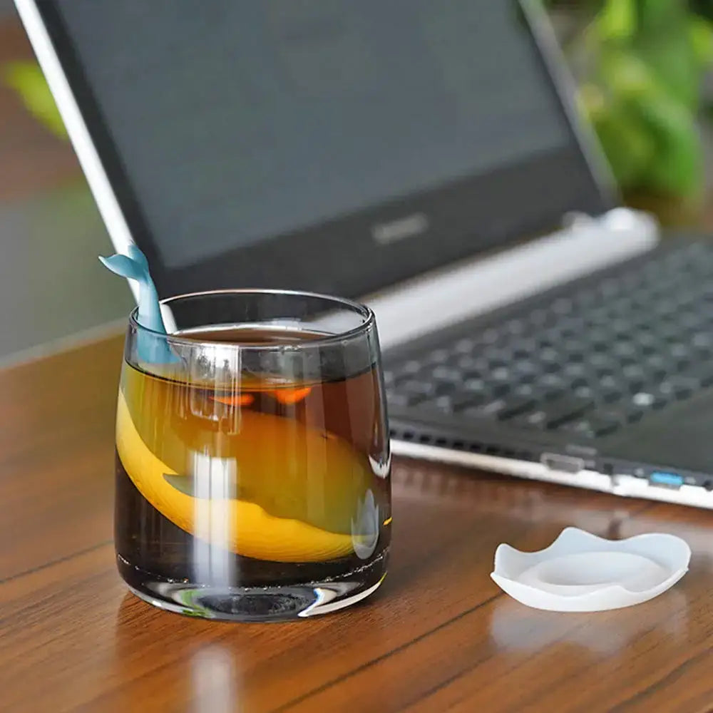 Whale tea infuser floating in a mug of tea