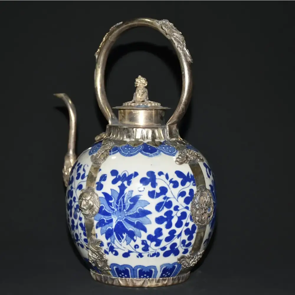 Blue porcelain teapot on wooden table with tea cup