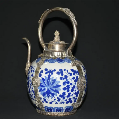 Blue porcelain teapot on wooden table with tea cup