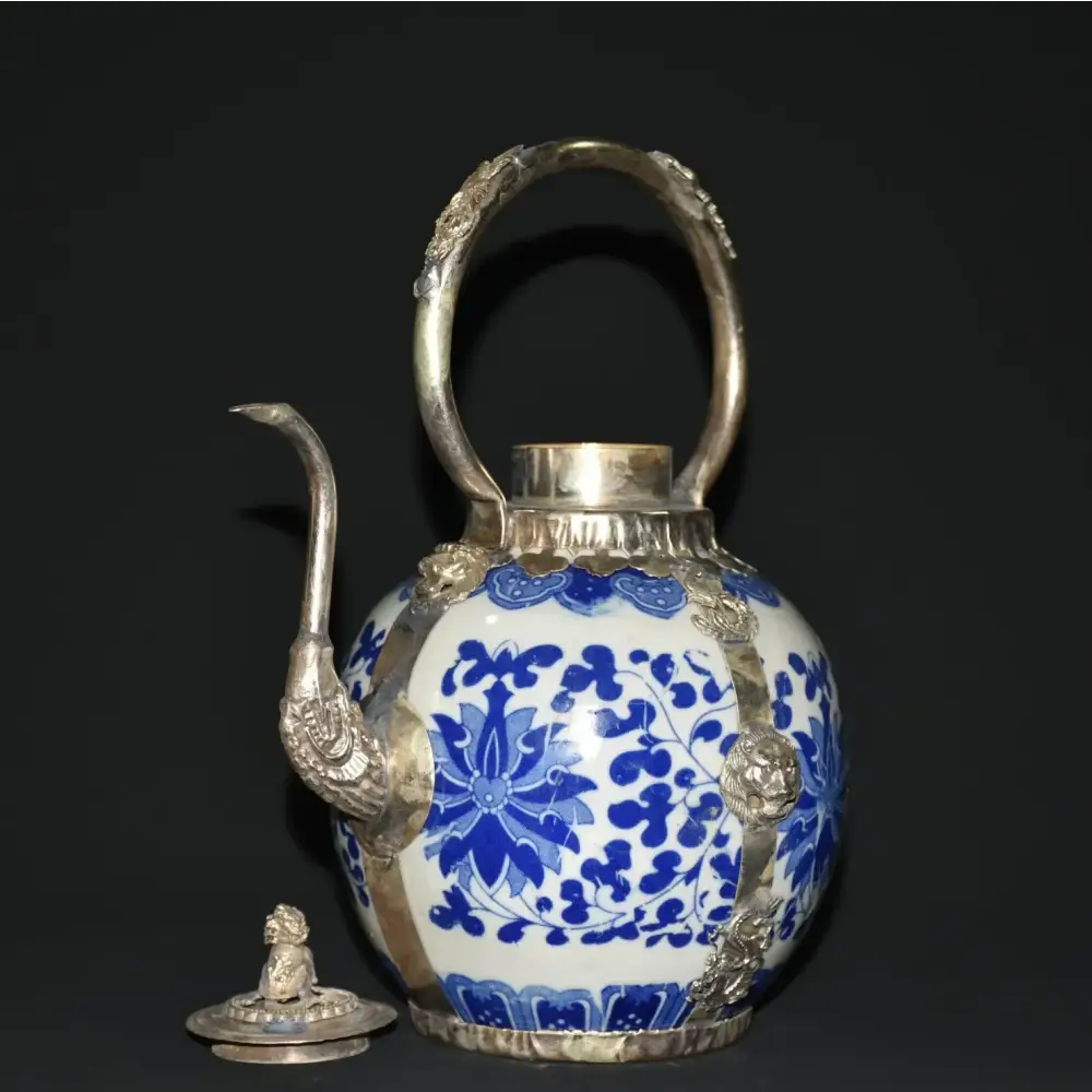 Antique porcelain teapot with nature scene decoration