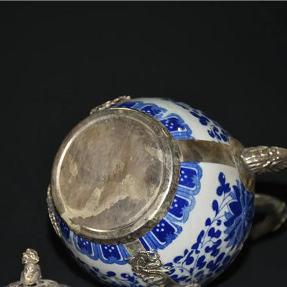 Elegant blue teapot on serving tray with tea set