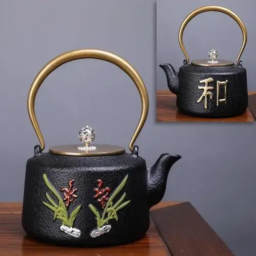 Black and gold enamel cast iron teapot with floral motifs