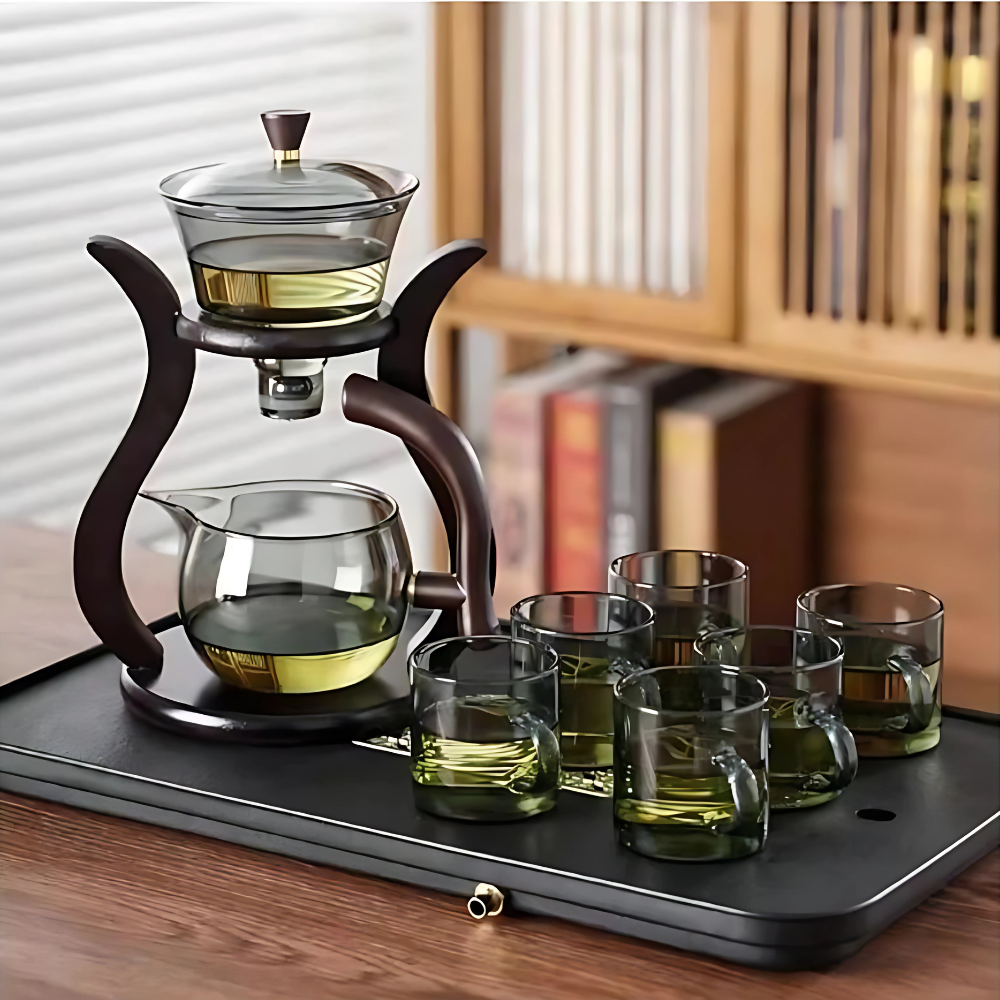 Glass teapot automatic infuser with metal lid on wooden surface