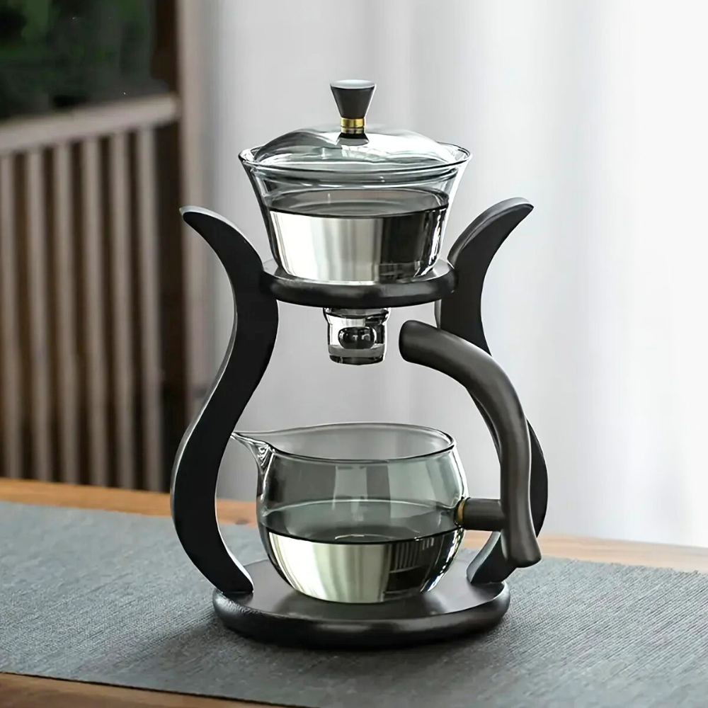 Automatic tea infuser with glass teapot and freshly brewed cup of tea