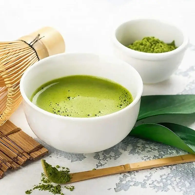 Close-up of bamboo matcha scoop with green tea powder