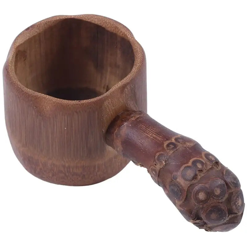 Bamboo tea infuser with fine mesh strainer on wooden table