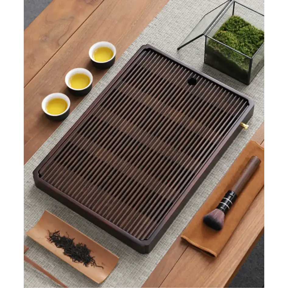 Bamboo tea tray with teapot and tea cups on side