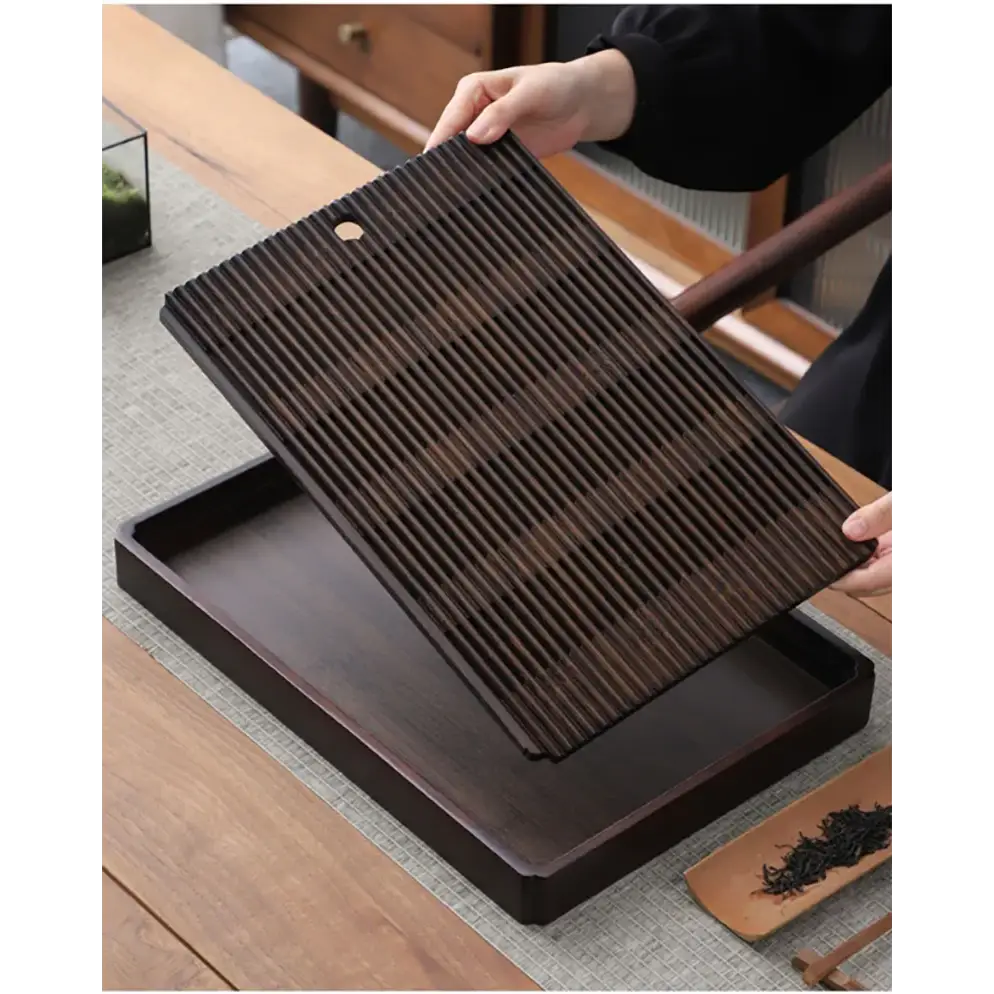 Bamboo tea tray holding a teapot and cups