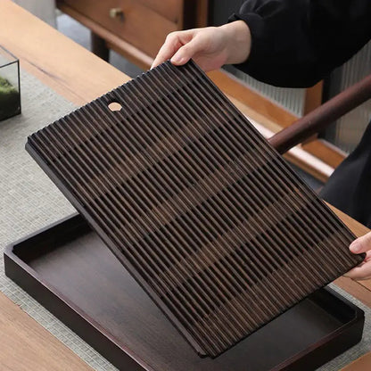 Bamboo tea tray on wooden table with tea accessories