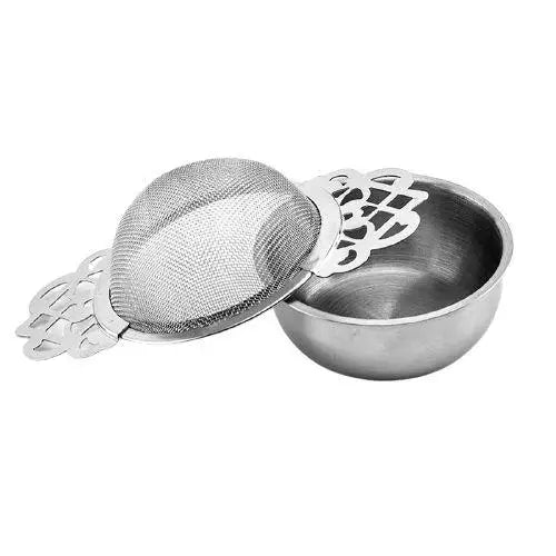 Baroque tea strainer sitting on a mug