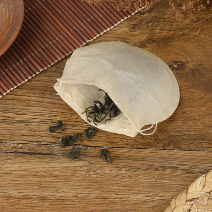 Empty drawstring tea filter bag close-up, unbleached plant fiber